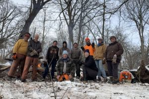 A group of people in the woods in winter.