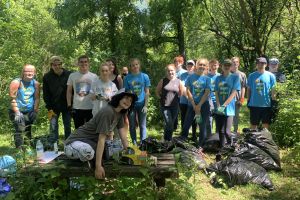 A group of students in a forest facing the camera.