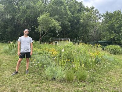 A man in yard with native plants