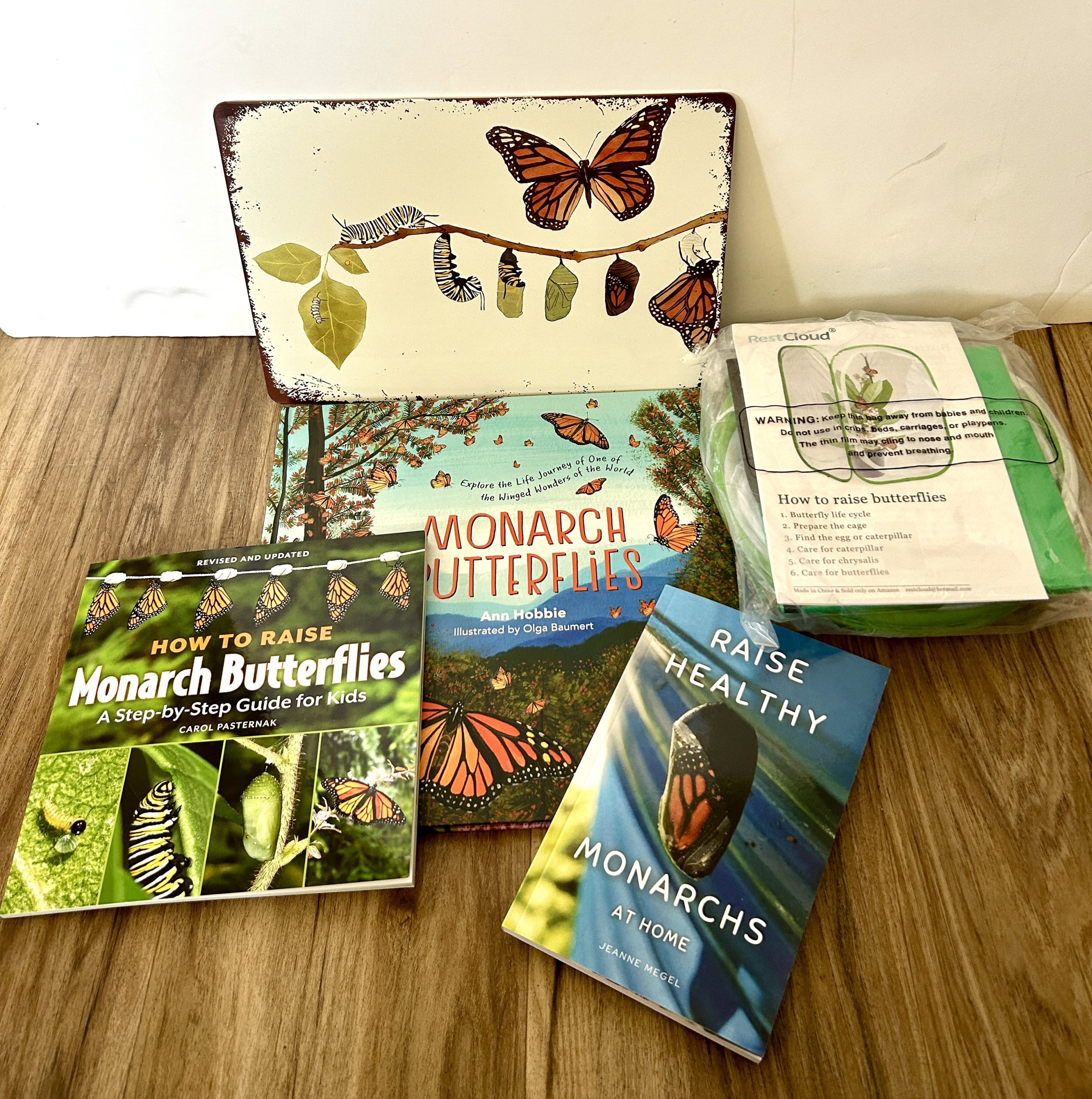 Monarch books, enclosure and a sign. Part of a silent auction gift basket.