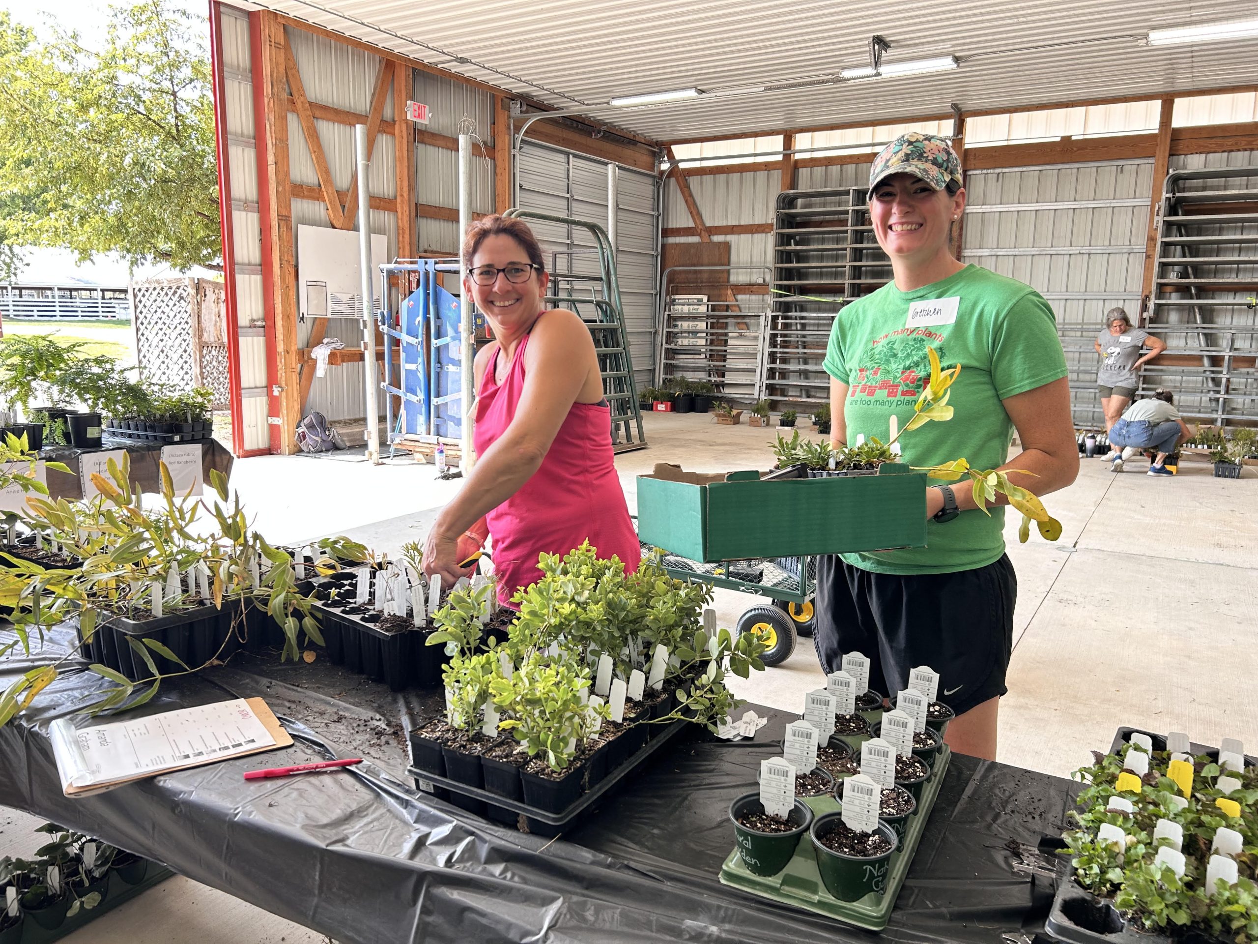 Two people with trays of plants