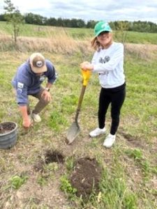 A girl with a shovel.