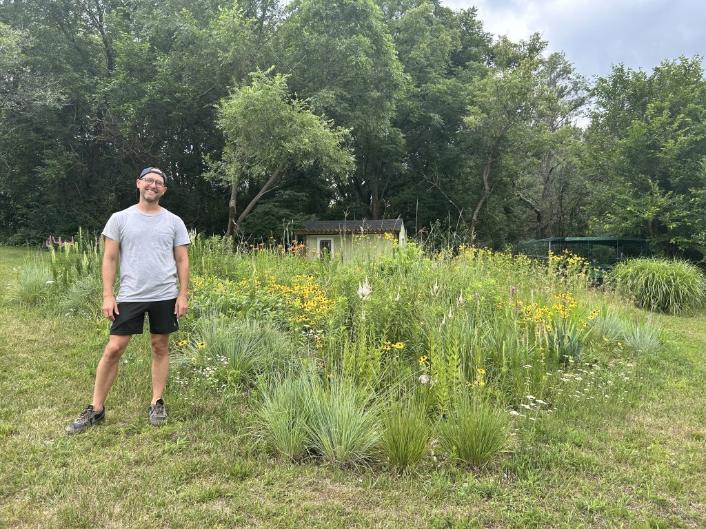 A man in yard with native plants
