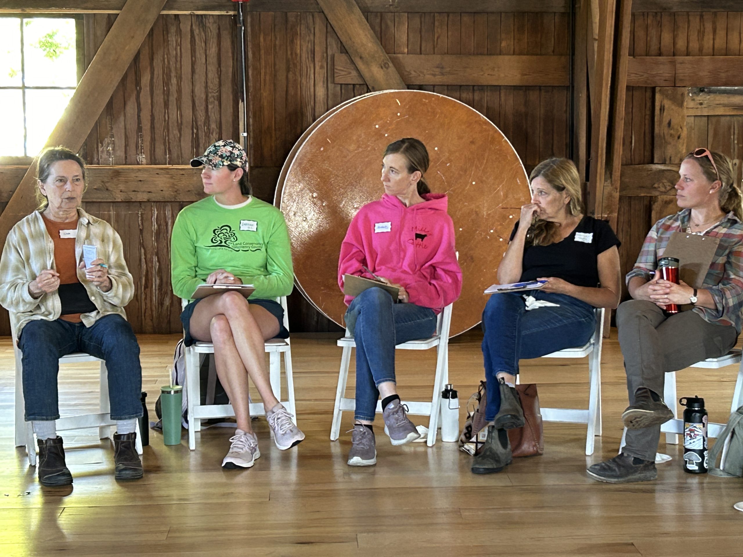 Women in chairs in a barn