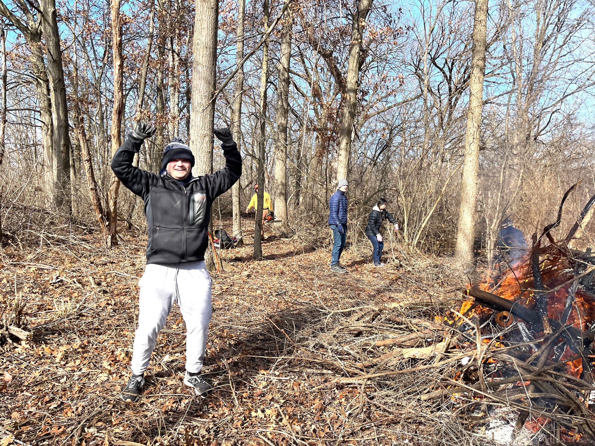 A man cheering in a winter forest.