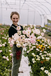 A woman cutflower grower holding a bouquet of flowers
