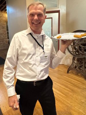 A man with a catering tray of appetizers at TLC's At of the Land fundraiser. 
