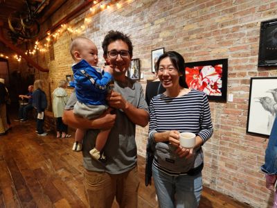 A couple with a toddler at art show.