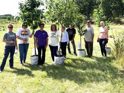 A group of people standing by native trees.
