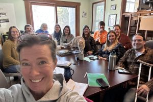 Fun selfie with TLC staff around a table.