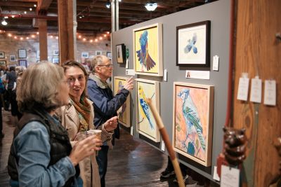 Guests viewing art at Art of the Land