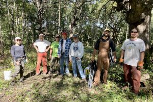 A group of people posing after a restoration workday